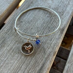 Silver-looking bracelet with dove charm